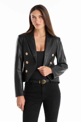 A woman in a black Gabrielle Leather Double Breasted Blazer with a tailored waist.