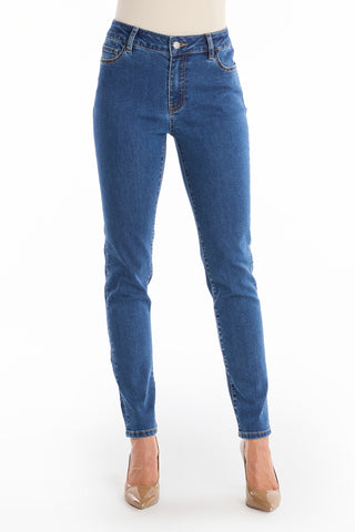 A person wearing the Layla Skinny Jean - Medium Blue with beige high-heeled shoes stands against a plain white background. The image is cropped at the waist, focusing on the jeans and shoes.