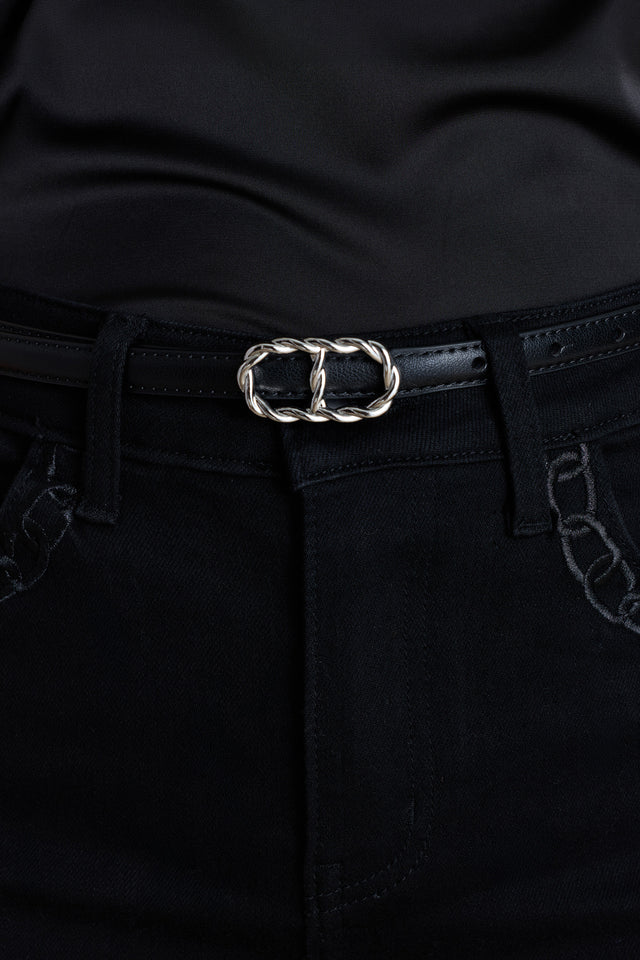 The Mabel Belt in black and silver worn at the waist, showing the interlocking oval buckle