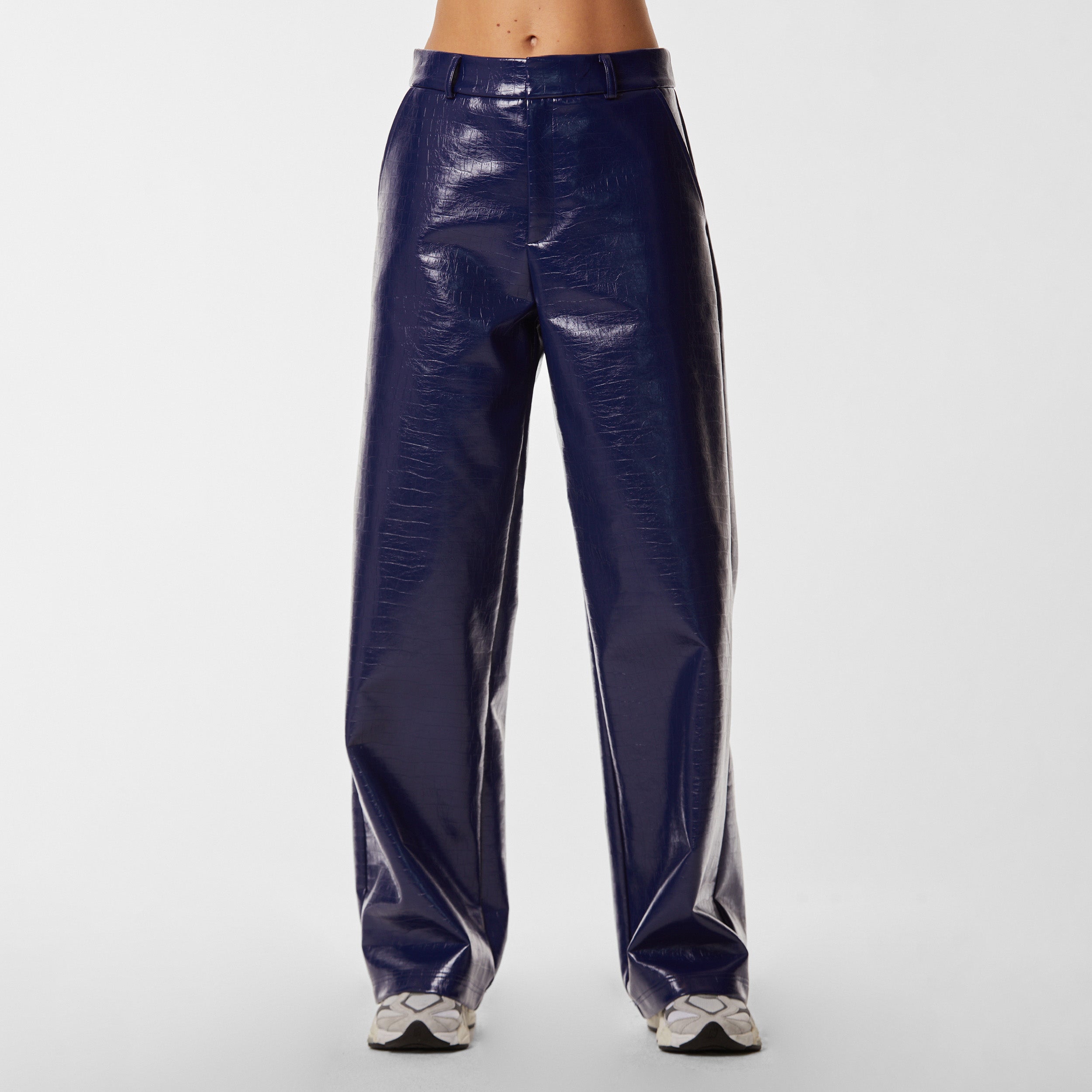 Front view of woman wearing navy blue faux leather croco pattern embossed wide leg pant.