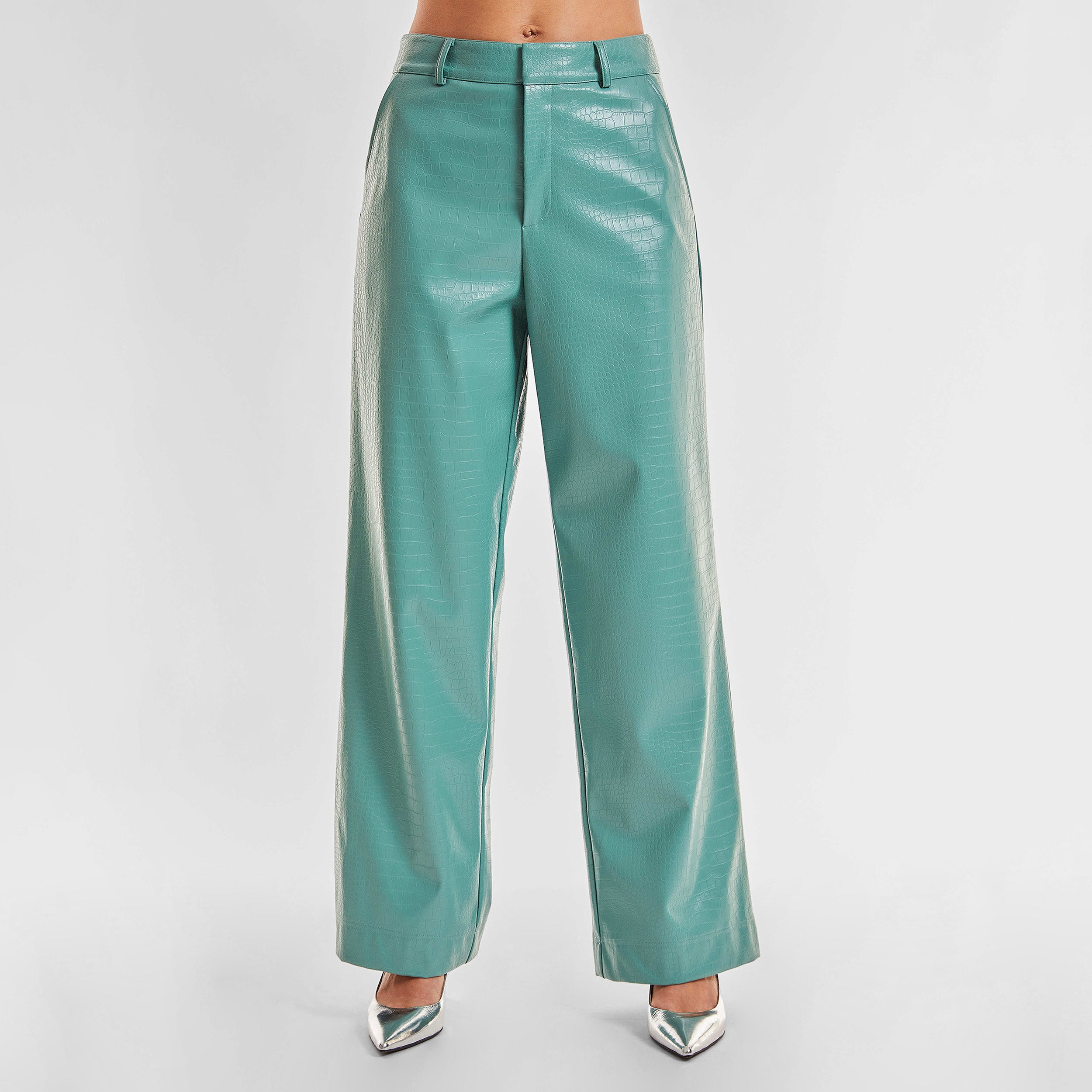 Front view of woman wearing sage colored faux leather croco pattern embossed wide leg pant.