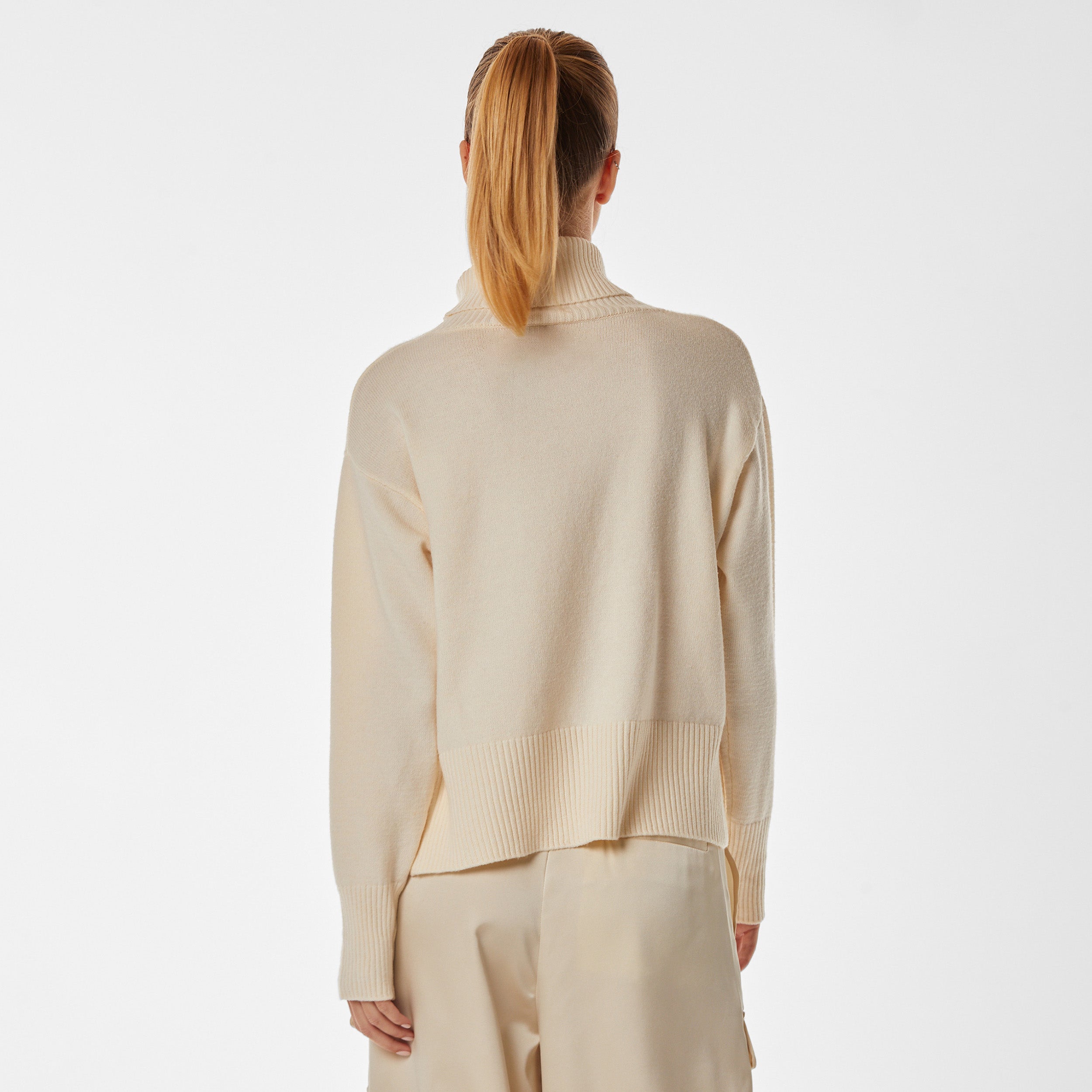Rear view of woman wearing pearl colored oversized sweater