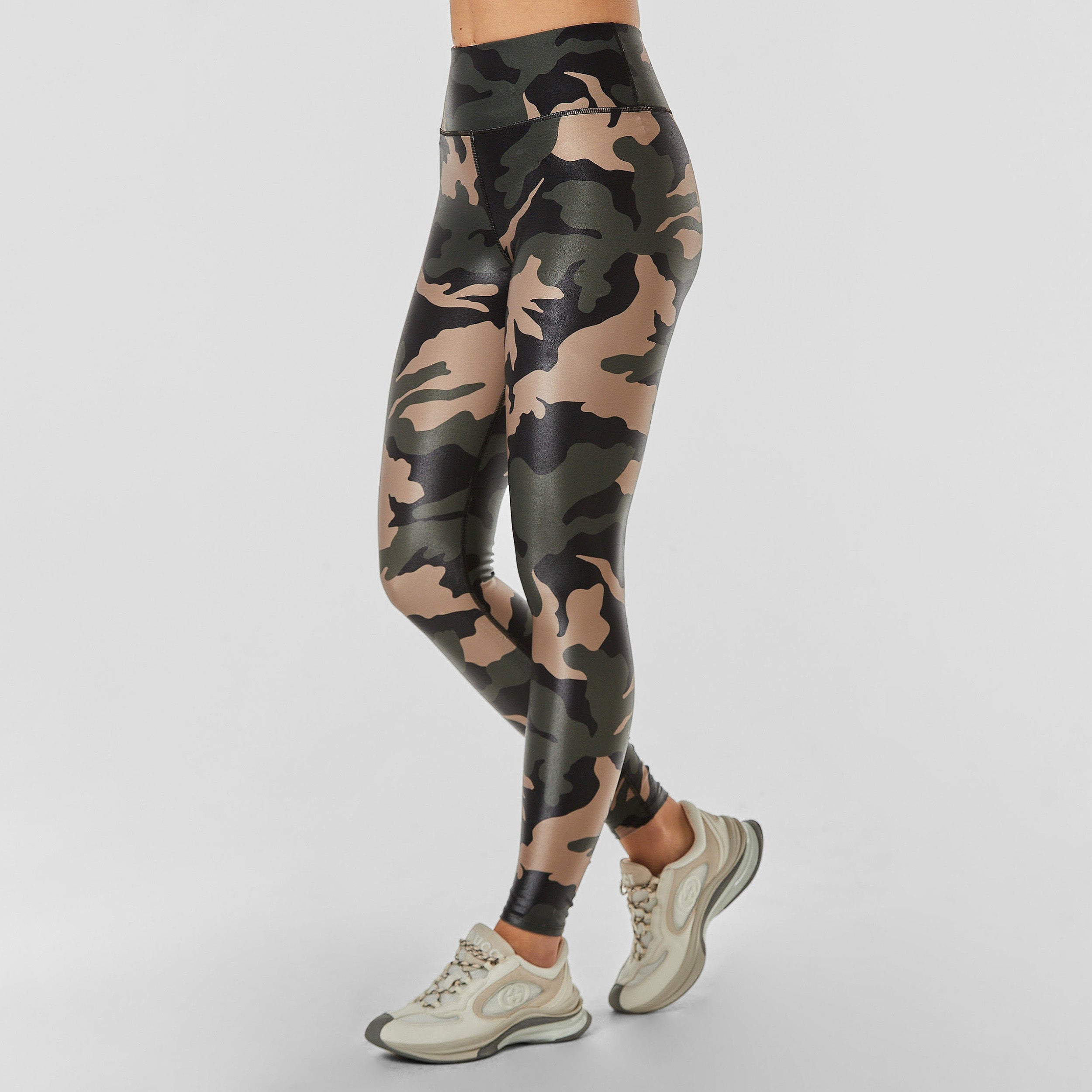 Side view of woman wearing lightweight, lustrous shine, quick drying camo printed liquid leggings