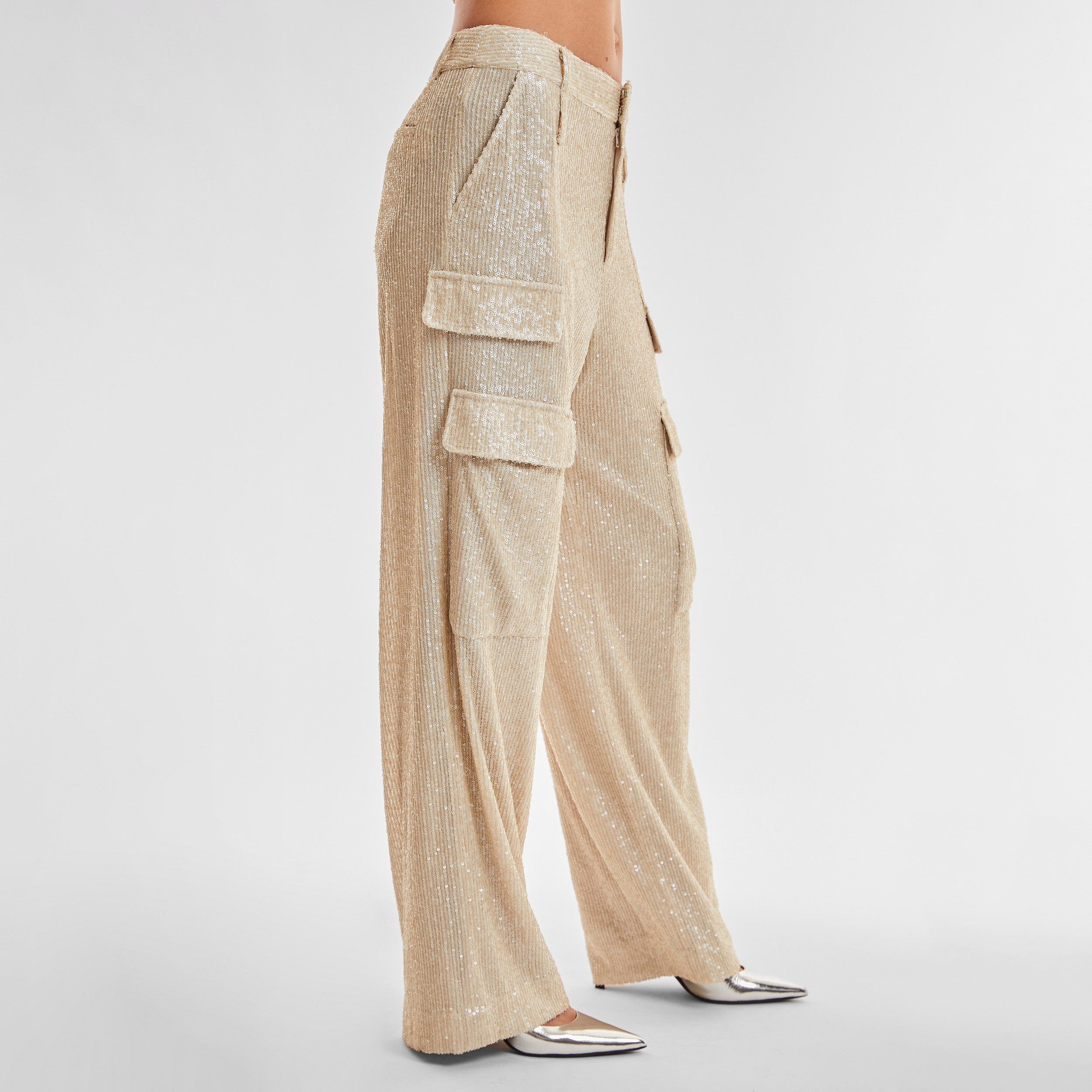 Side view of woman wearing Pearl Sequin Cargo Pant featuring Mid-rise with side pockets and cargo detail. 