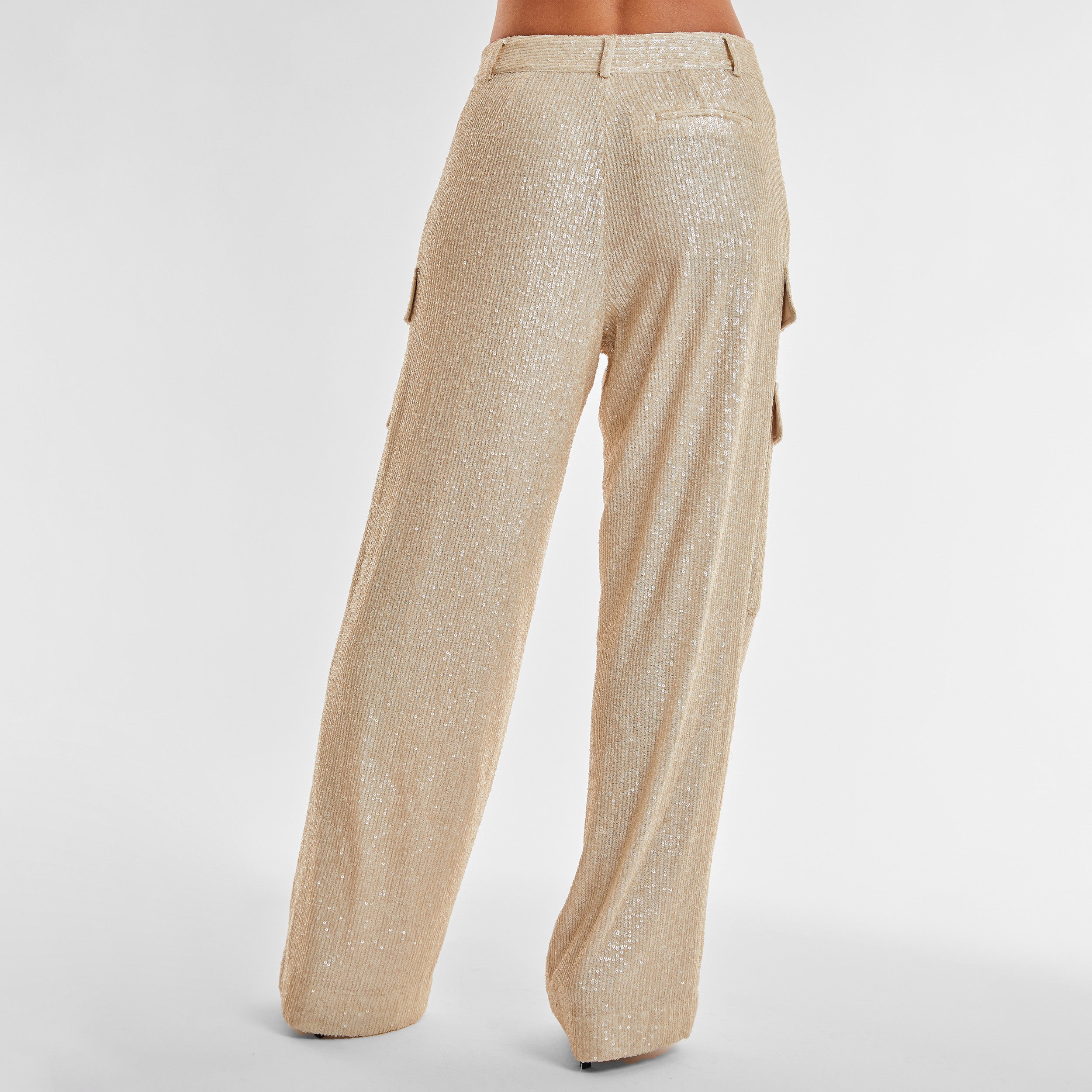 Rear view of woman wearing Pearl Sequin Cargo Pant featuring Mid-rise with side pockets and cargo detail. 