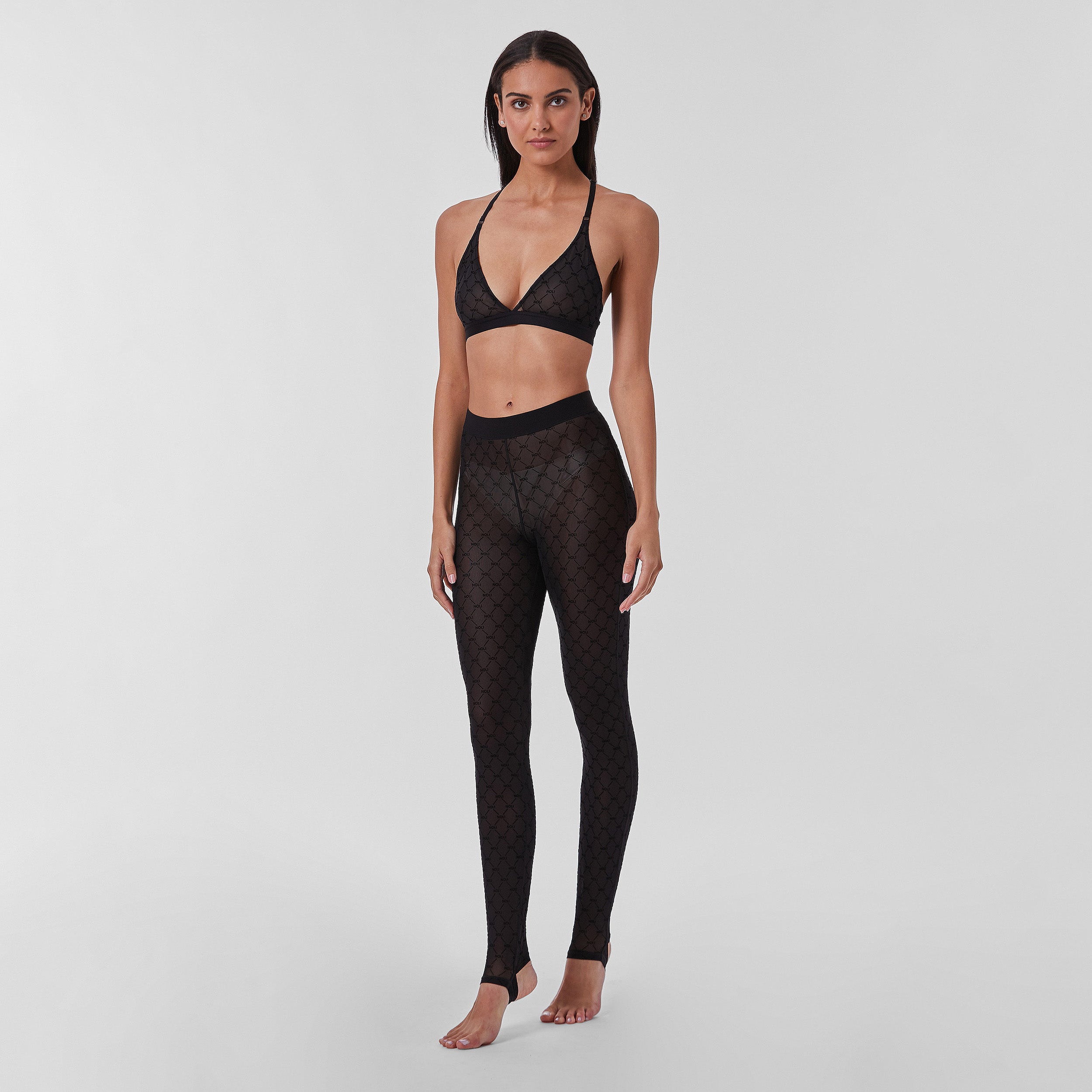 Full view of woman wearing tights featuring ultra-soft and comfortable NOLI monogram mesh, slip this four-way stretch mesh