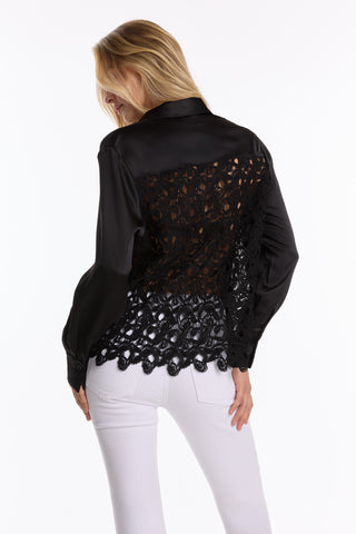 A woman in the Amelia Silky Lace Blouse - Black (Preorder).