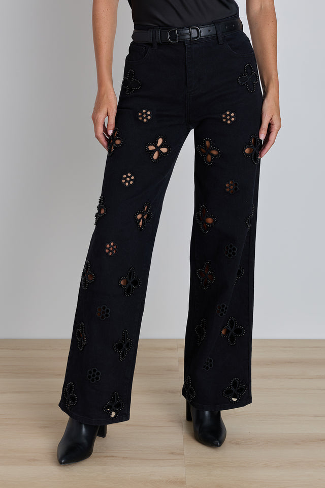 The Kaia Pearl High Rise Jean in black, wide-leg stretch denim with white daisy cutout details