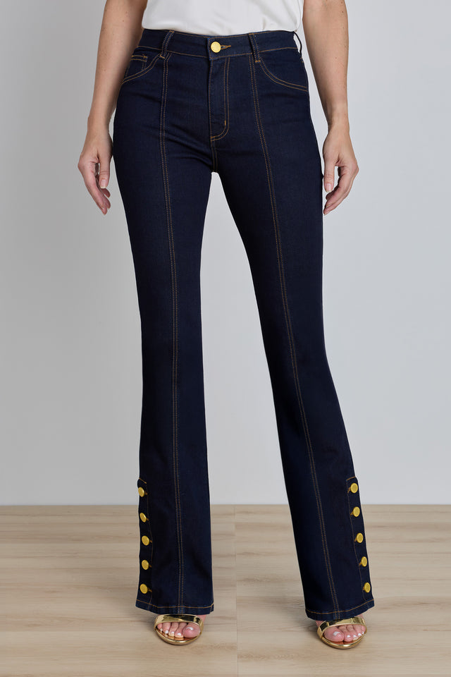 The Veronica Button Jean in indigo, mid-rise flared dark denim with gold buttons at the ankle