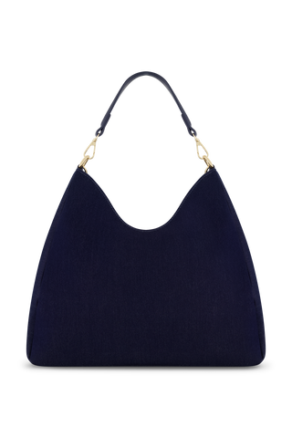 The Tribeca Chain Denim Bag - Indigo Denim features a luxe indigo denim finish and a short handle with a gold chain, displayed against a plain white background.