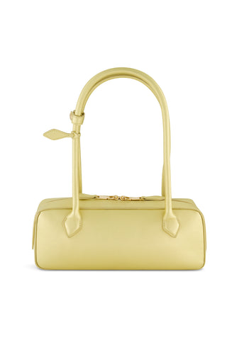 The Reese Metallic Leather Bag - Gold is a rectangular light yellow handbag with two long handles—one adorned with a decorative knot. It features a smooth texture, minimalist design, and elegant gold hardware for refined style.