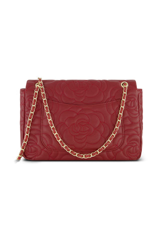 The Alessia Rose Embossed Leather Bag in Merlot features quilted floral patterns and a gold chain strap, displayed against a white background.