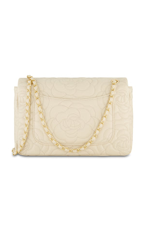 The Alessia Rose Embossed Leather Bag - Pearl is a pearl-colored handbag with a rose-embossed design, featuring a gold chain strap threaded with matching leather.