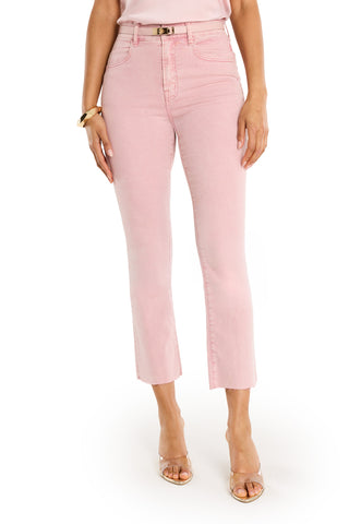 A woman models the Nicolette Cropped Jean - Blush, a high-waisted, light pink denim with a raw hem and four-way stretch, paired with a beige top, gold bracelet, and clear heels for an effortless summer look against a white background.