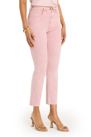 A woman models summer style in the Nicolette Cropped Jean - Blush, high-waisted and four-way stretch, paired with a pale pink top, gold bracelet, and clear strap heeled sandals against a white background.