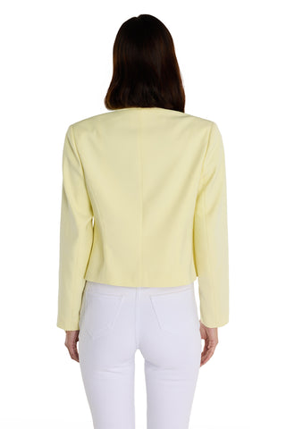 A person with long brown hair is shown from the back wearing a Gabrielle Double Breasted Blazer - Sunshine Yellow with a tailored waist and white pants, standing against a plain white background.