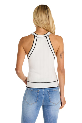 A woman with long blonde hair is seen from the back, wearing the Martha Button Halter Tank in white with black trim and light blue jeans. She has a tattoo on her left upper arm.
