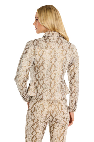 A woman with long blonde hair is seen from behind, wearing the Bethanie Denim Jacket - Gold Python, standing against a white background.