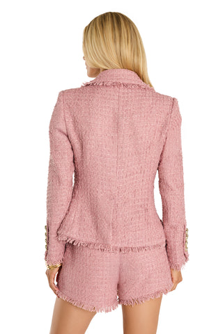 A blonde woman stands with her back to the camera, wearing the Giselle Single Breasted Tweed Blazer in blush and matching frayed shorts.