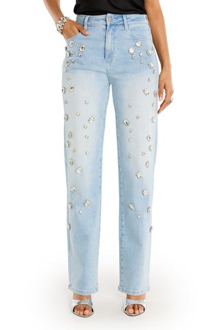 A person wears the Tara Crystal Jean - Light Blue, a high-rise stretch denim jean embellished with sparkling rhinestones, paired with open-toe heels and a black top. Only the lower half of the body is visible.