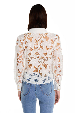 A woman is shown from the back against a plain white background wearing light blue jeans and the Mina Lace Blouse in white, featuring long sleeves and intricate sheer floral lace.