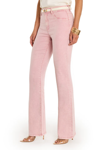 A person wearing the Aria Flare Jean - Blush, styled with a white top, gold bracelets, and clear high heels. The cropped image shows the outfit from shoulders down against a white background.