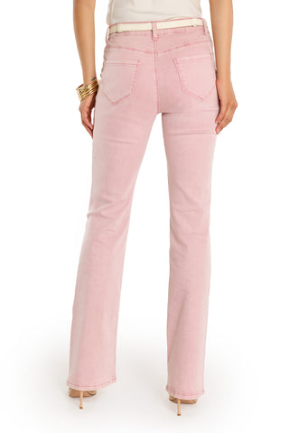 A person is shown from the back wearing the Aria Flare Jean - Blush, a white belt, nude heels, gold bangles, and a white top.