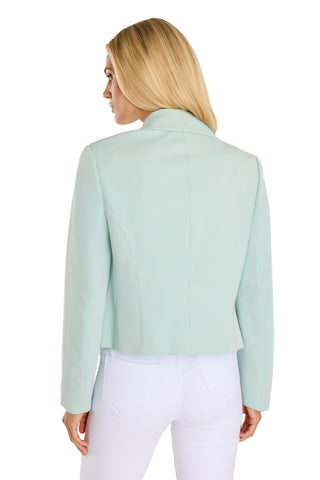 Blonde woman in a tailored waist, mint Gabrielle Double Breasted Blazer and white pants stands with her back to the camera, looking over her left shoulder against a white background.