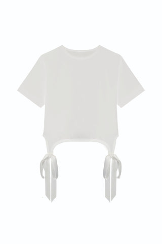 The Diana Satin Bow Shirt – White is a short-sleeve cotton crop top with two side hem slits, each accented by a white satin bow. The shirt is plain white and the background is solid white.