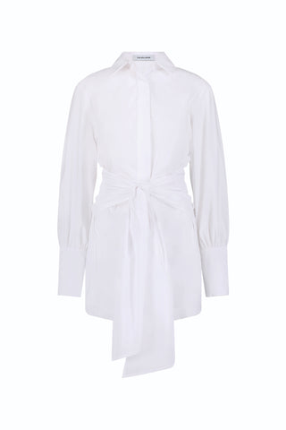 The Lana Dress - White features a long-sleeve, collared poplin design with a button-down front and oversized cuffs. A front tie detail at the waist adds a modern touch and creates a flattering, draped silhouette.