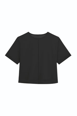The Naya Suede T-Shirt - Black is a minimalist short-sleeve tee with a round neckline and subtle center seam, shown on a white background. Its simple design makes it perfect for layering.
