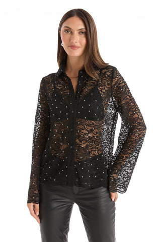 A woman wears the Jena Lace Button Up Shirt in black, featuring long sleeves and floral lace, paired with black leather pants. She has straight brown hair and stands against a white background.
