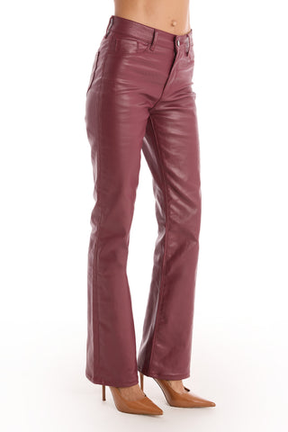 A person wearing merlot Aria Coated Flare Jeans and tan pointed-toe heels, photographed against a white background.