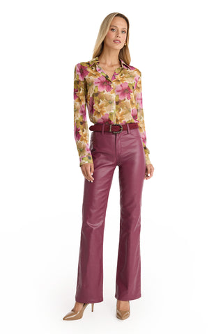 A woman stands against a white background wearing a floral blouse, high-waisted magenta pants, beige heels, and the Samantha Belt - Merlot with a chic cowboy buckle.