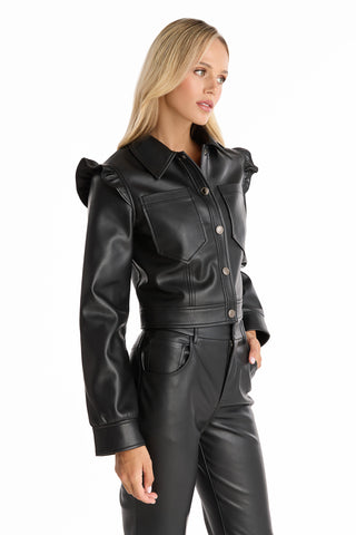 A woman with long blonde hair models the Chantal Ruffle Sleeve Leather Jacket in black, paired with high-waisted pants against a white background—an ideal statement piece for fall.