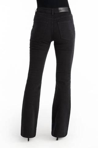 Person wearing Allegra Rose Jean - Black and a black top, seen from the back. The jeans have rose buttons, two back pockets, a fitted waist, and flared legs. The background is plain white.