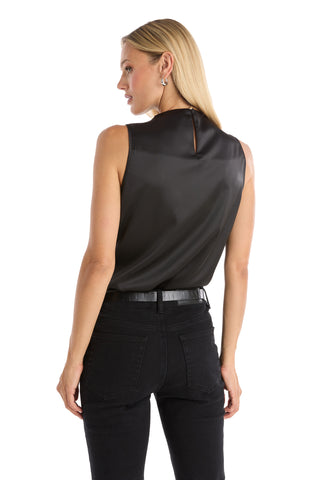 Woman with straight blonde hair wears the Mara Silky Top - Black, an elegant sleeveless mock neck style, paired with black jeans and faces away from the camera against a white background.