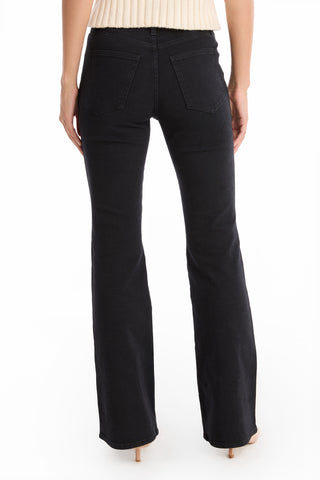 A person is seen from the back, wearing Allegra Bootcut Jean - Black with a beige knit top, standing against a white background.