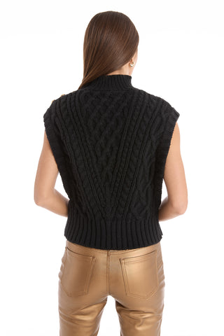 A woman wearing the Raina Cable Knit Button Sweater in black.