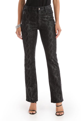 A person wearing black Aria Coated Flare Jeans in a python print, a black sleeveless top, black high-heeled sandals, and silver bangles stands against a white background.