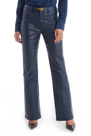 A person wears Aria Coated Flare Jean - Navy with a matching blue shirt and black pointed-toe heels, standing against a white background.