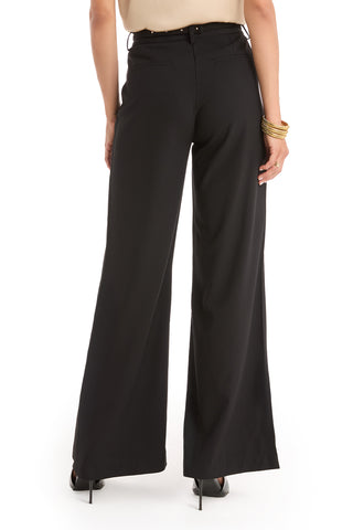 A person shown from the back against a white background wears the Martina Belted Trouser - Black, paired with black heels, a beige top, and gold bangles.