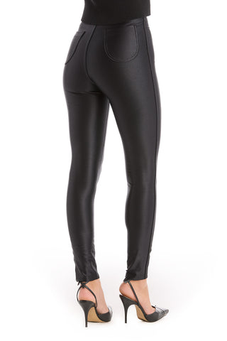 A person shown from the back wears Suzette Skinny Pant - Black, featuring a high-rise waist and paired with black high-heeled shoes, standing against a white background.