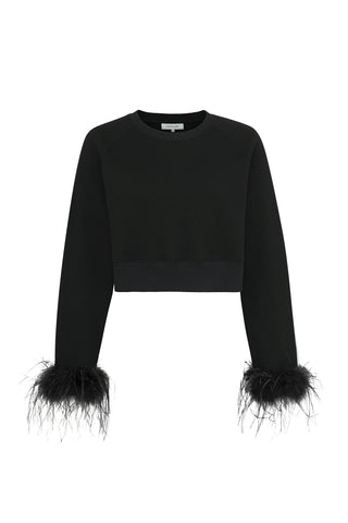 The Rada Feather Trim Crewneck - Black is a black cropped sweater made from French Terry, featuring long sleeves and ostrich feather trims at the cuffs. Its simple, elegant design is enhanced by the sophisticated and stylish touch of feather detailing.