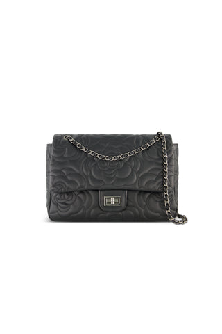 The Alessia Rose Embossed Leather Bag - Black features a rose-embossed design, silver rectangular clasp, and an elegant chain strap draped over the front.