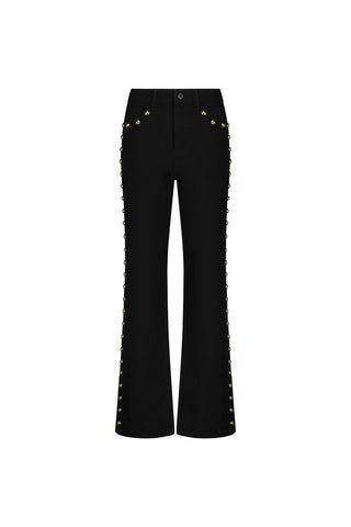 The Leah Studded Jean - Black features four-way stretch denim, front pockets, and gold studs along the side seams from hip to hem, shown against a white background.
