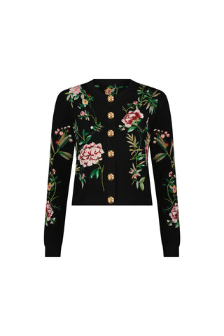 The Alyssa Jacquard Cardigan - Black Floral is a black long-sleeve knit featuring gold buttons and colorful embroidered pink flowers with green leaves on the front, sleeves, and shoulders.