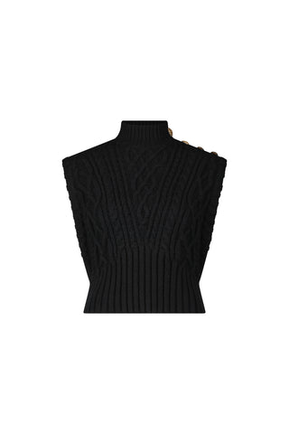 The Raina Cable Knit Button Sweater - Black is a sleeveless, chunky cable-knit vest with a mock turtleneck and gold button shoulder detail, shown on a plain white background.