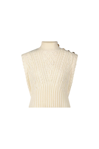 The Raina Cable Knit Button Sweater in Pearl is a sleeveless sweater vest featuring a mock turtleneck, ribbed hem, and decorative shoulder buttons.