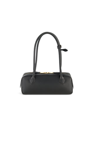 The Reese Leather Bag - Black is a structured rectangular handbag with two long handles, modern gold hardware, and a zip closure, showcased against a white background.